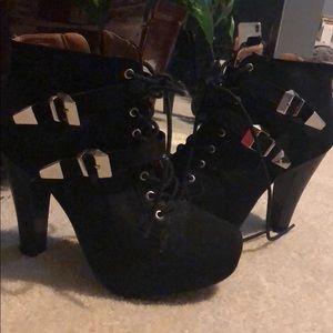 Black lace up strapped booties. Heels